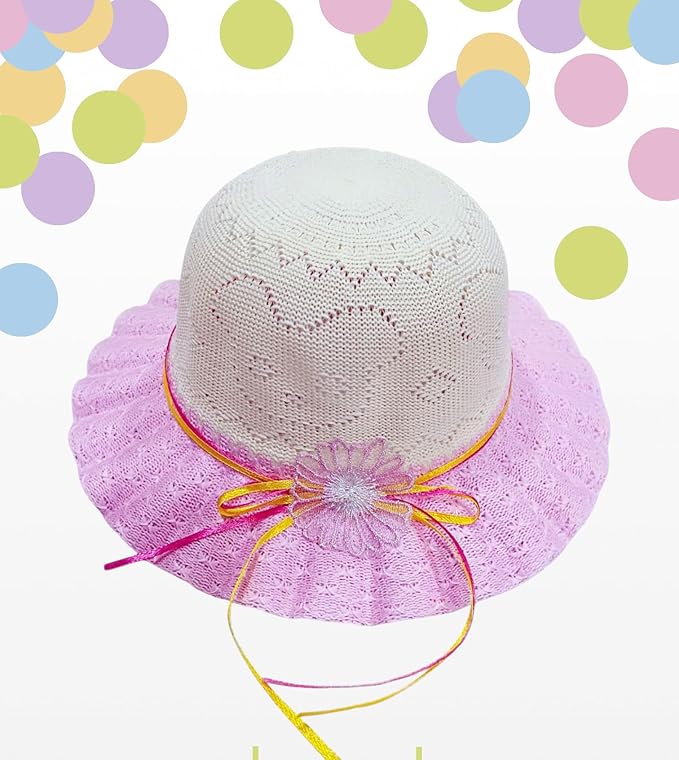 The image shows a white crocheted hat with a pink lace brim, featuring a pink and yellow ribbon with a decorative bow, set against a white background with colorful circular patterns.